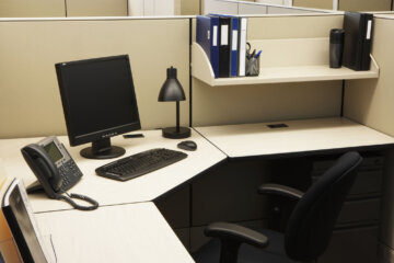 Computer and files in an office are seen in this stock photo.