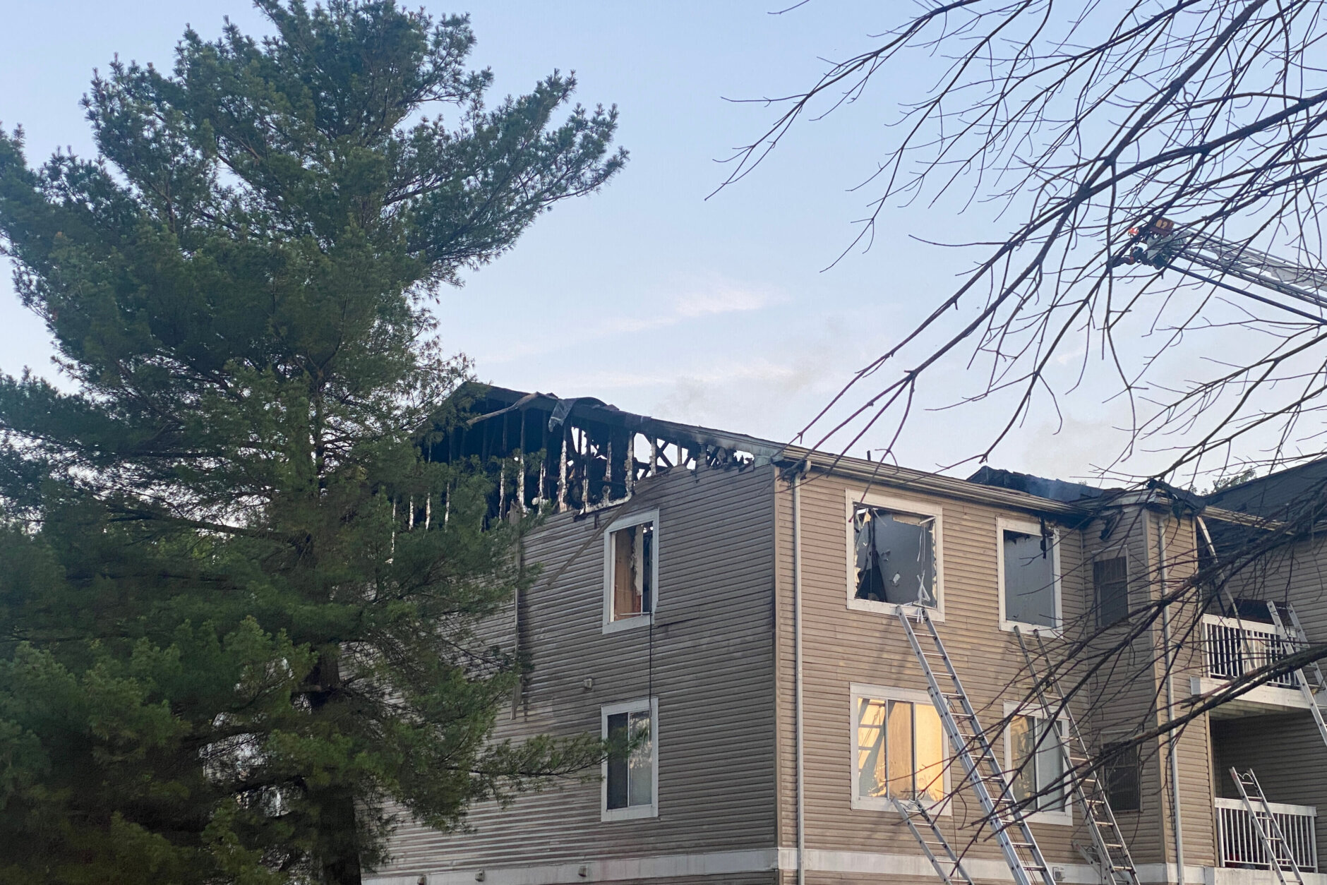 Collapsed roof, broken windows following apartment building fire