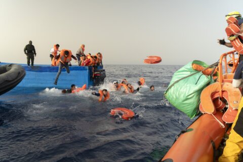 Armed bandits interrupt a rescue of migrants in the Mediterranean off Libya, an aid group says