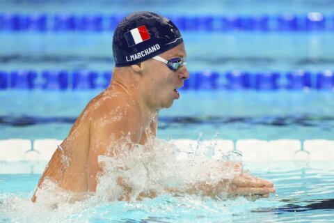 With French fans cheering every stroke, Marchand cruises to fastest time in men's medley