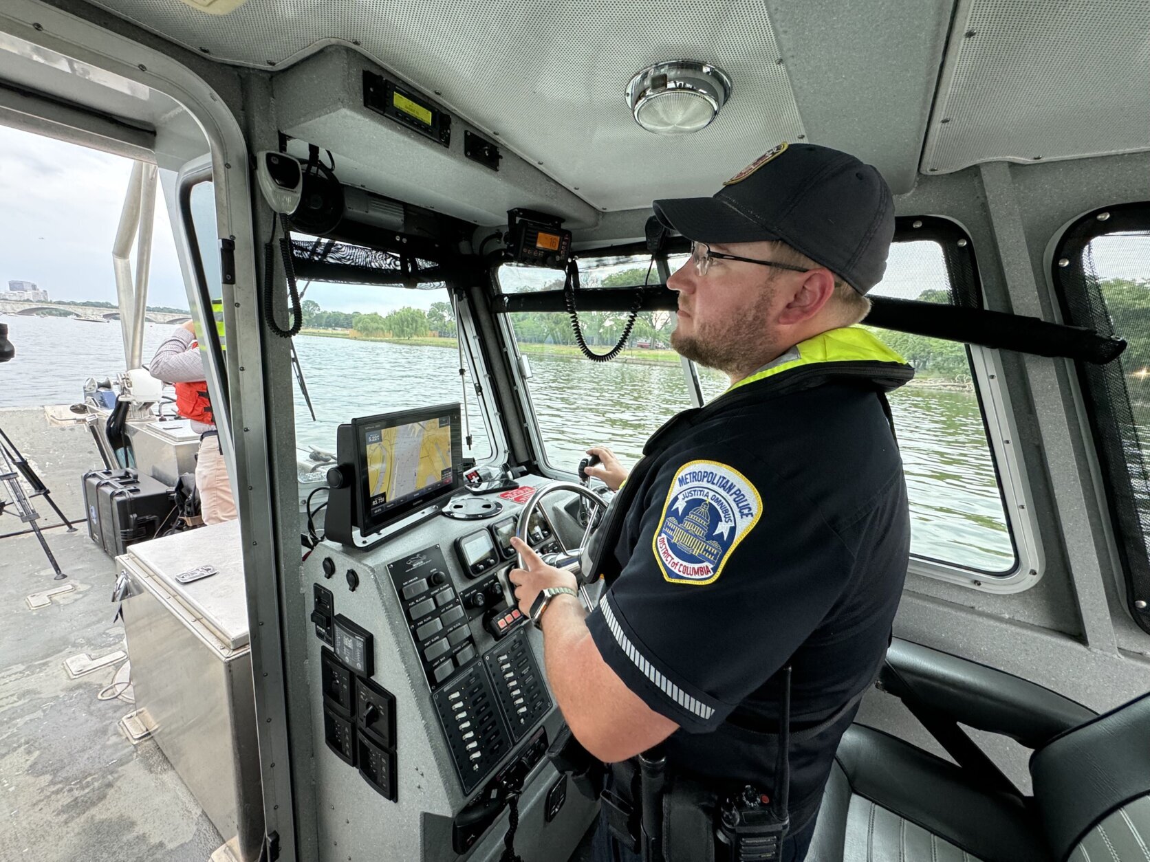 a harbor patrol unit officer steers