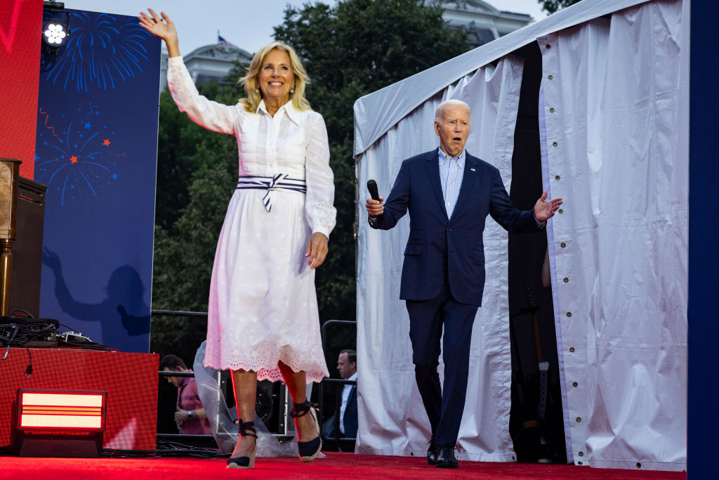 First Lady Jill Biden and President Joe Biden walk on stage