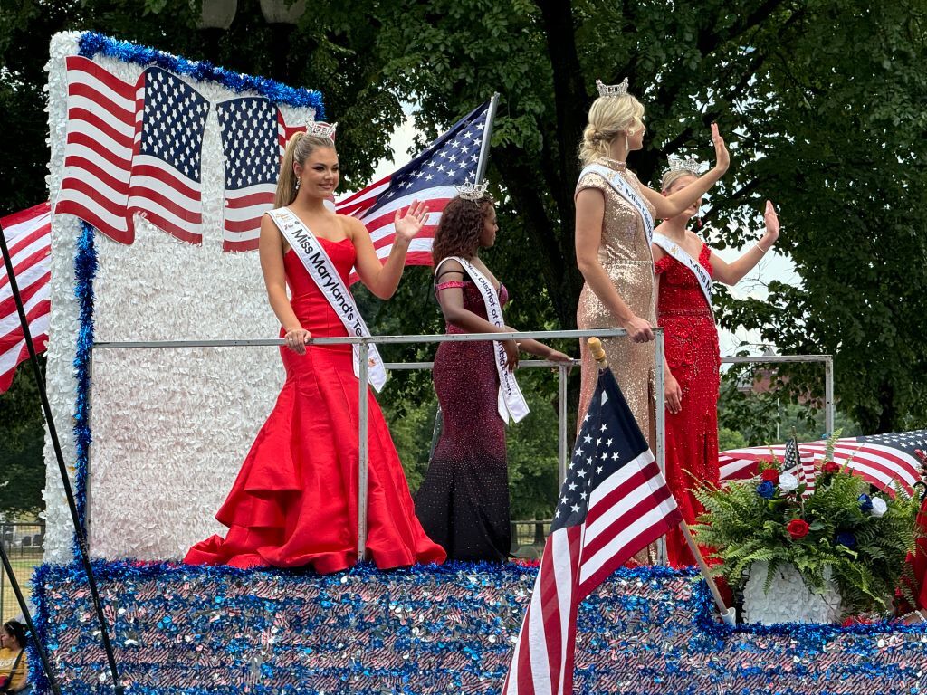 Beauty Queens ride a float during a parade celebrating Independence Day