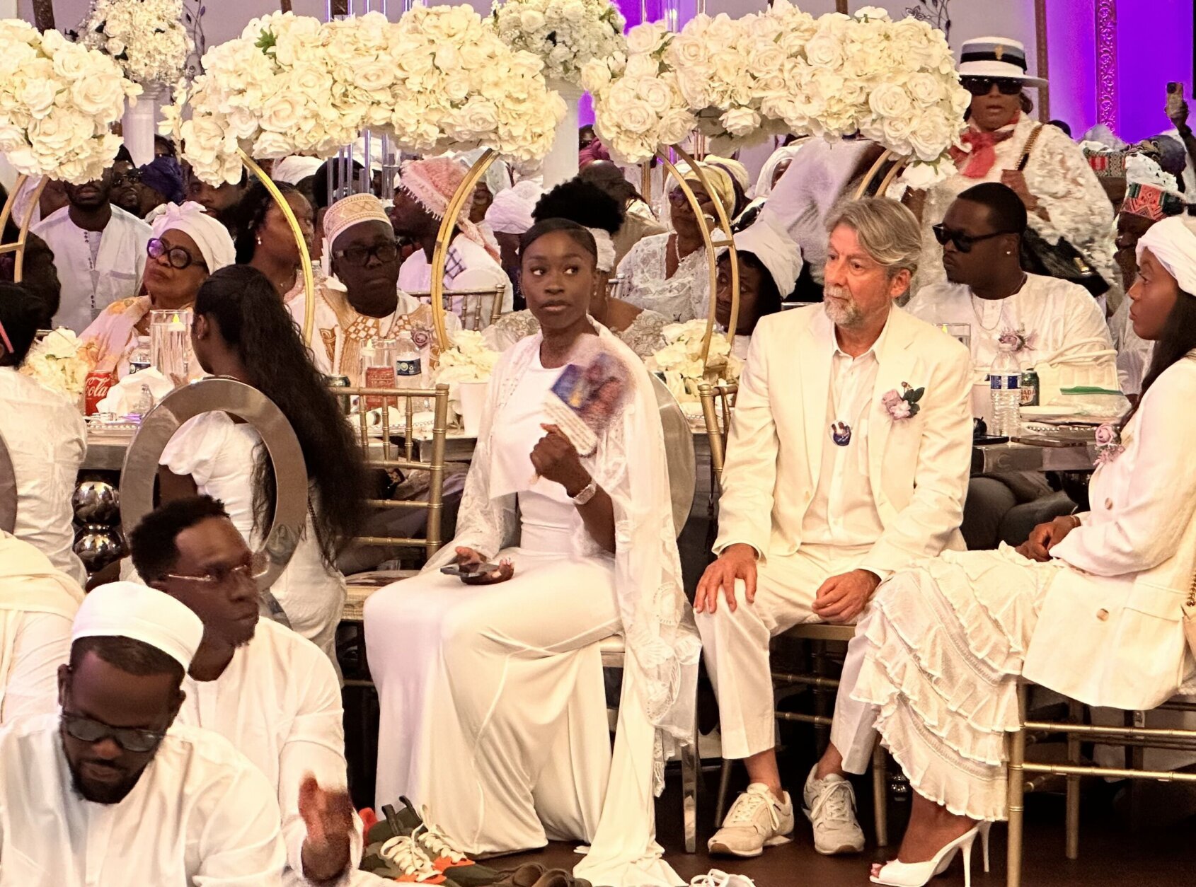 Saida Wurie listens to speakers during the her parents memorial service.