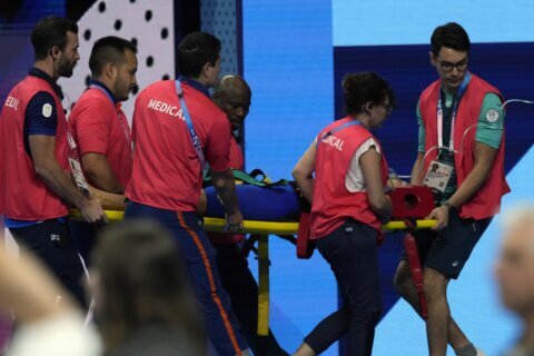 Swimmer Tamara Potocka collapses after a women’s 200-meter individual medley race at the Olympics