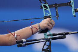 Casey Kaufhold, of the United States, competes along with Brady Ellison during the Archery mixed team quarterfinal against , Japan's Satsuki Noda and Japan's Junya Nakanishi at the 2024 Summer Olympics, Friday, Aug. 2, 2024, in Paris, France. (AP Photo/Brynn Anderson)