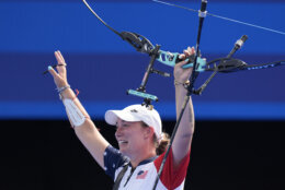 Casey Kaufhold, of the United States celebrates with Brady Ellison after winning the Archery mixed team bronze medal match against India's Ankita Bhakat and Dhiraj Bommadevara at the 2024 Summer Olympics, Friday, Aug. 2, 2024, in Paris, France. (AP Photo/Brynn Anderson)