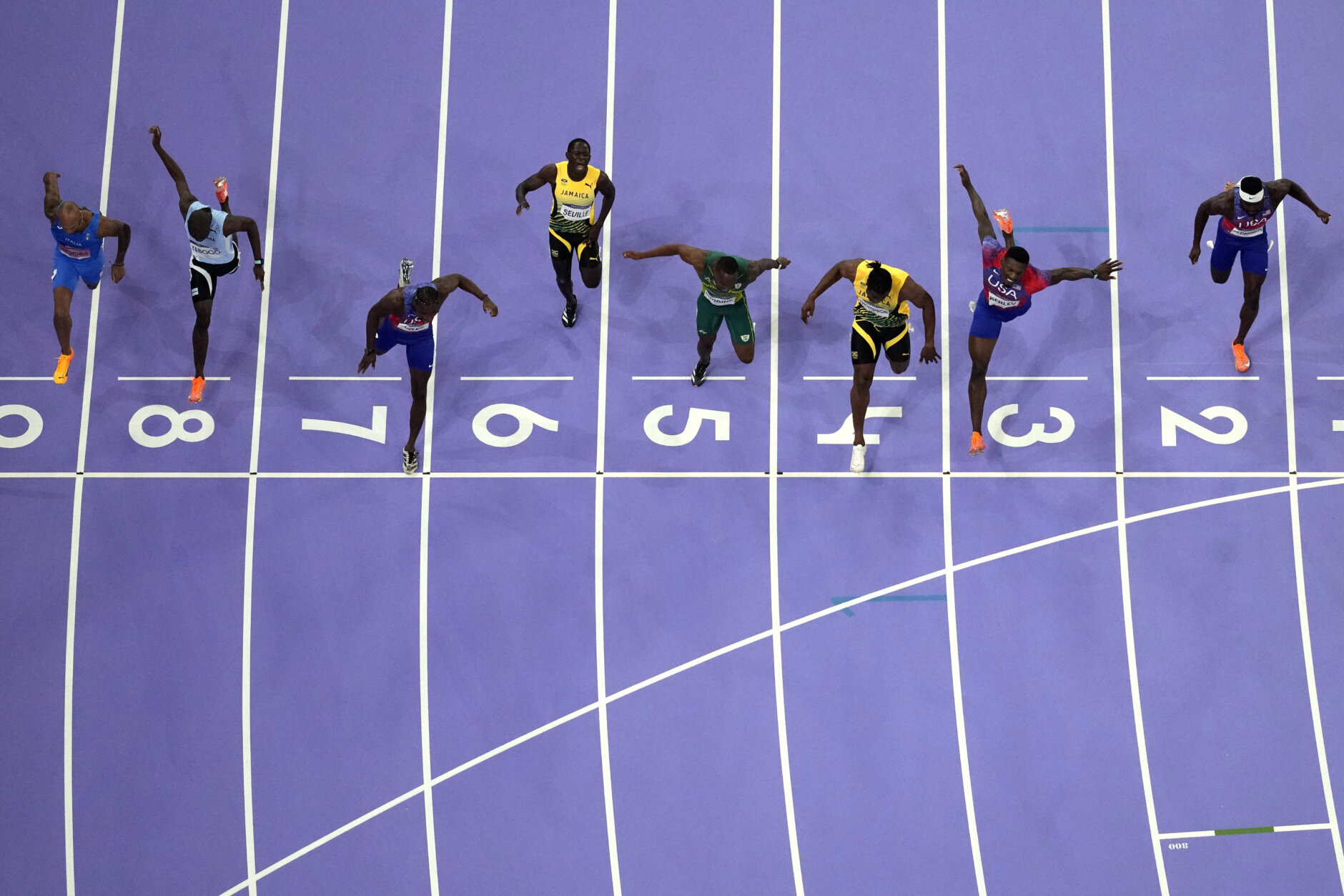 Noah Lyles, of the United States, in lane seven, wins the men's 100-meter final at the 2024 Summer Olympics, Sunday, Aug. 4, 2024, in Saint-Denis, France. (AP Photo/David J. Phillip)