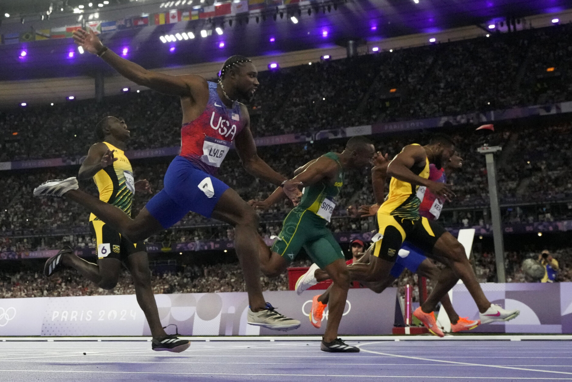 Noah Lyles, of the United States, wins the men's 100-meter final ahead of Kishane Thompson, of Jamaica, at the 2024 Summer Olympics, Sunday, Aug. 4, 2024, in Saint-Denis, France. (AP Photo/Petr David Josek)