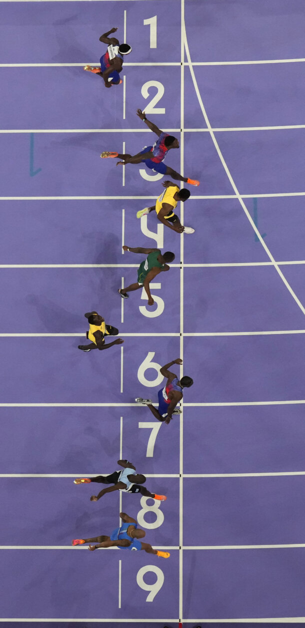 Noah Lyles, of the United States, in lane seven, wins the men's 100-meter final at the 2024 Summer Olympics, Sunday, Aug. 4, 2024, in Saint-Denis, France. (AP Photo/David J. Phillip)