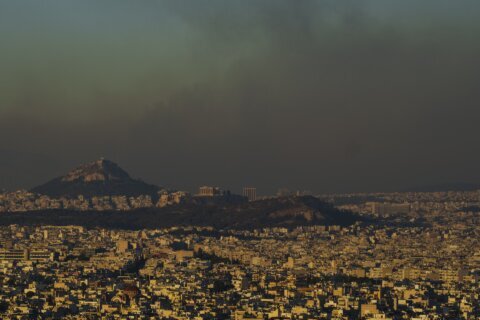 Crews battle scattered fires in Athens suburbs, helped by calmer winds and reinforcements