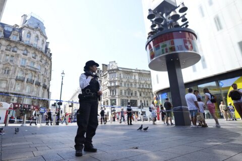 London police say a girl and a woman were stabbed in the busy theater district and a man is arrested