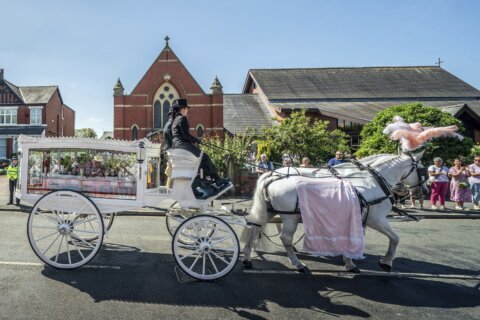 English town of Southport mourns 9-year-old stabbing victim and calls for an end to unrest