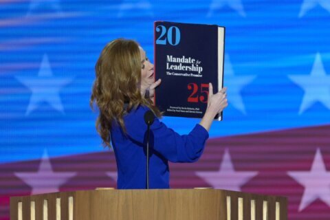 Throwing the book: Democrats enlarge a copy of the 'Project 2025' blueprint as an anti-GOP prop