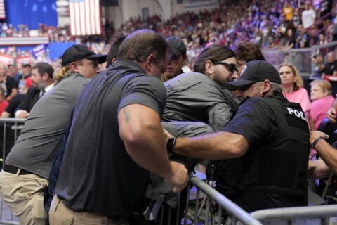 Police say a man will face charges after storming into the press area at a Trump rally