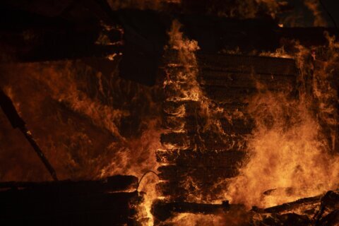 Hundreds of firefighters tackle a major wildfire raging out of control on fringes of Greek capital