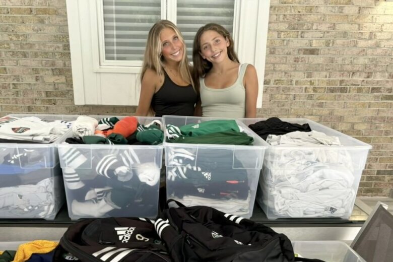 sisters stand with donated clothes