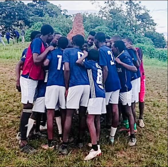 kids in zambia huddle wearing donated jerseys