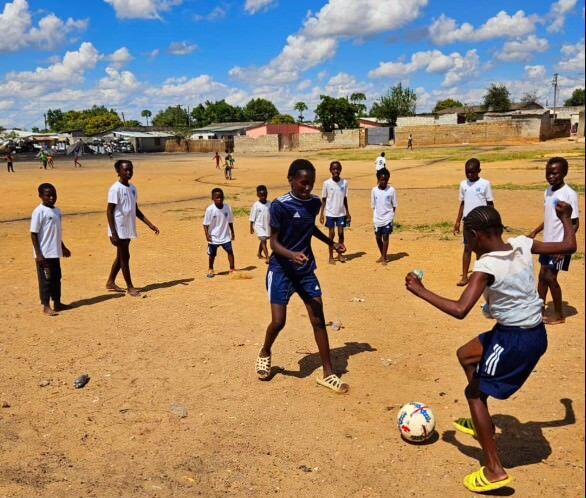 Kids in Zambia play soccer wearing donated jerseys