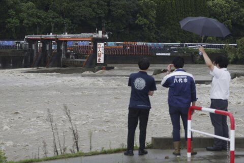 Slow tropical storm dumps heavy rain around Tokyo after causing floods in southern Japan