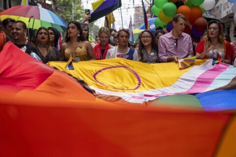 Same-sex couples and LGBTQ+ activists rally in Nepal's capital during the annual Pride parade