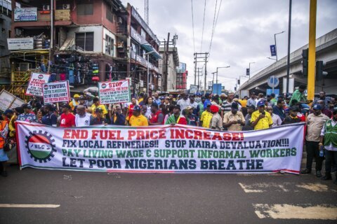 Police fire gunshots and tear gas as thousands protest Nigeria’s crisis. Reports say 2 were killed