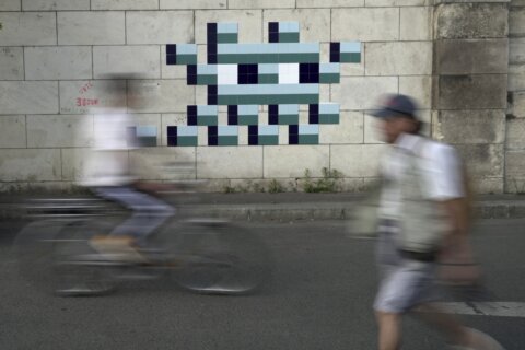 Mystery Paris street artist ‘Invader’ glues up new work to celebrate Olympics and delight fans