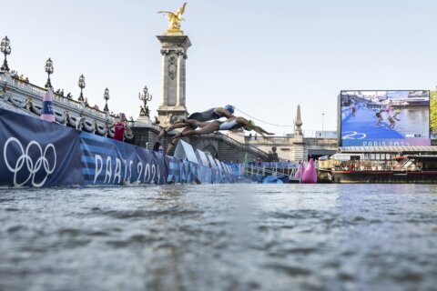 Amid concerns about dirty water and strong current, marathon swimmers dive into the Seine River