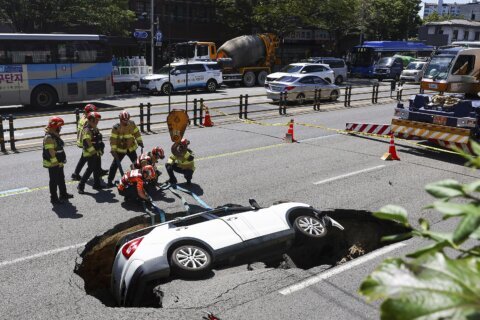 A sinkhole swallows an SUV in South Korea, injuring 2 people