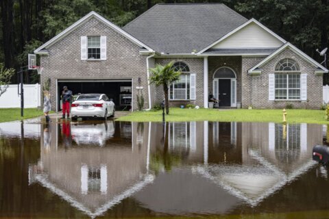 Tropical rains flood homes in an inland Georgia neighborhood for the second time since 2016