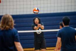 high school student punts volleyball