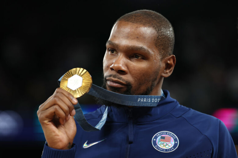 Kevin Durant holds up gold medal