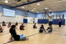 pe teachers teaches kids who are sitting