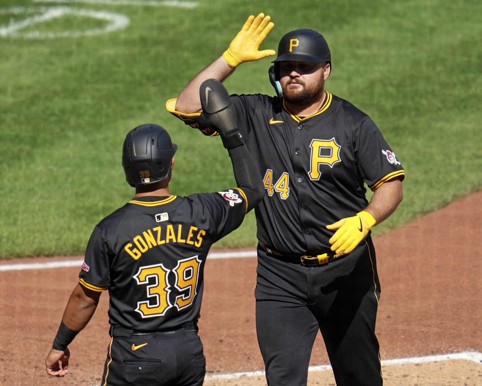 Pittsburgh Pirates' Rowdy Tellez (44) celebrates with Nick Gonzales after hitting a two-run home run off Washington Nationals relief pitcher Jacob Barnes during the seventh inning of the first baseball game of a split doubleheader in Pittsburgh, Saturday, Sept. 7, 2024. (AP Photo/Gene J. Puskar)