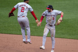 Washington Nationals' Dylan Crews (3) celebrates with Luis García Jr. after getting the final out of the first baseball game of a split doubleheader against the Pittsburgh Pirates in Pittsburgh, Saturday, Sept. 7, 2024. (AP Photo/Gene J. Puskar)