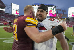 Washington Commanders center Tyler Biadasz, left, greets Tampa Bay Buccaneers defensive tackle Vita Vea on the field after an NFL football game Sunday, Sept. 8, 2024, in Tampa, Fla. (AP Photo/Chris O'Meara)