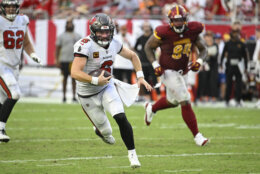 Tampa Bay Buccaneers quarterback Baker Mayfield (6) scrambles past Washington Commanders defensive tackle Daron Payne (94) for yardage during the second half of an NFL football game Sunday, Sept. 8, 2024, in Tampa, Fla. (AP Photo/Jason Behnken)