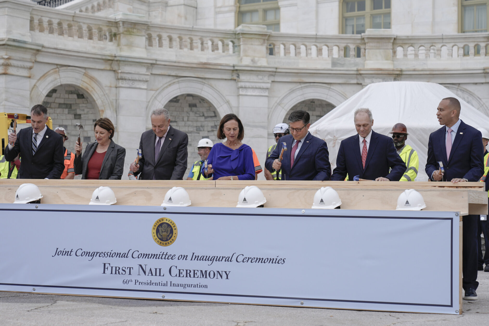 Congress members hammer in the first nails at the First Nail Ceremony marking the beginning of construction of the 2025 Presidential Inauguration platform on the steps of the Capitol, Wednesday, Sept. 18, 2024, in Washington. (AP Photo/Mariam Zuhaib)