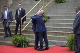 Maryland Gov. Wes Moore, left, hugs King Abdullah II ibn Al Hussein of Jordan at the Maryland State House in Annapolis, Md., after participating in a roundtable discussion, Wednesday, Sept. 25, 2024. (AP Photo/Stephanie Scarbrough)