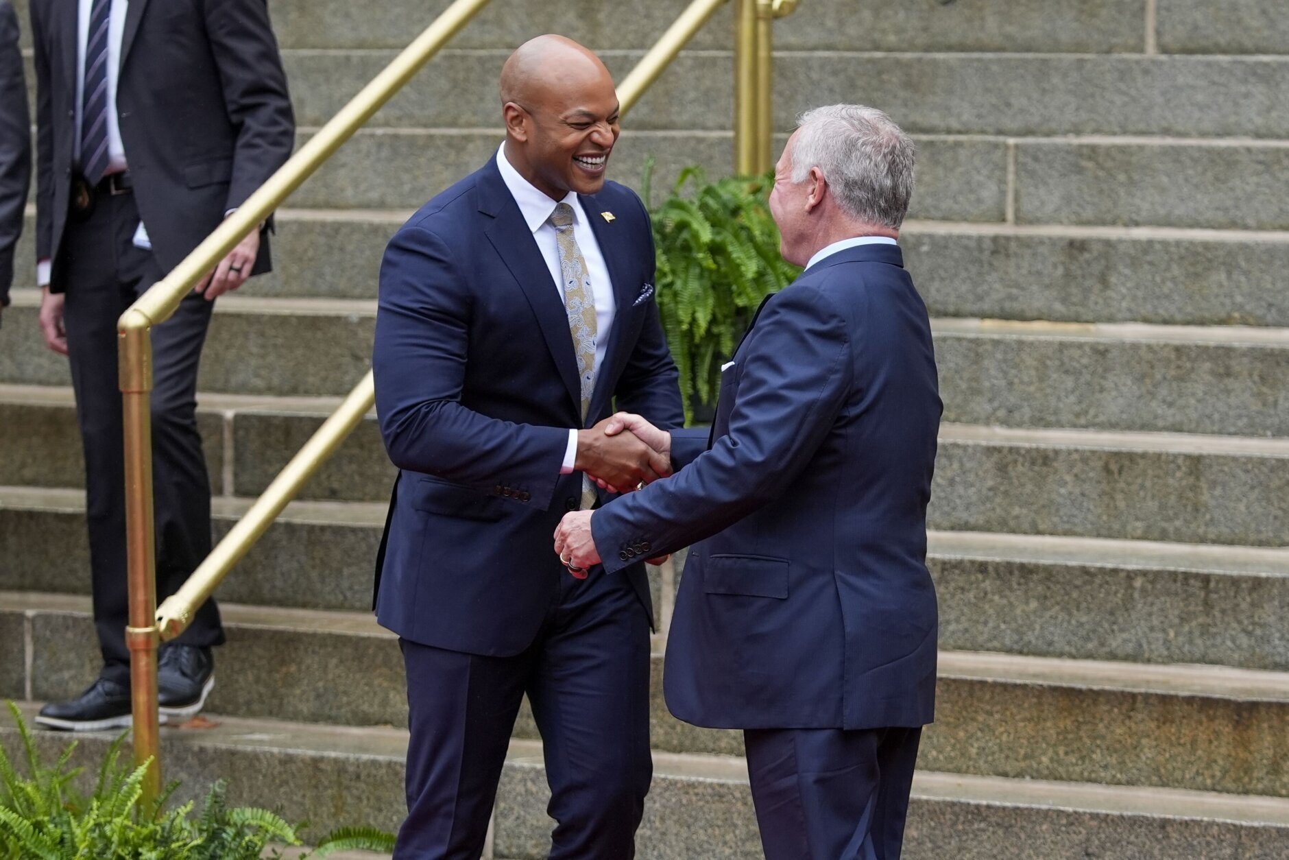 Maryland Gov. Wes Moore, left, shakes hands with King Abdullah II ibn Al Hussein of Jordan at the Maryland State House in Annapolis, Md., after participating in a roundtable discussion, Wednesday, Sept. 25, 2024. (AP Photo/Stephanie Scarbrough)