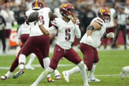 Washington Commanders quarterback Jayden Daniels (5) throws against the Arizona Cardinals during the first half of an NFL football game, Sunday, Sept. 29, 2024, in Glendale, Ariz. (AP Photo/Ross D. Franklin)