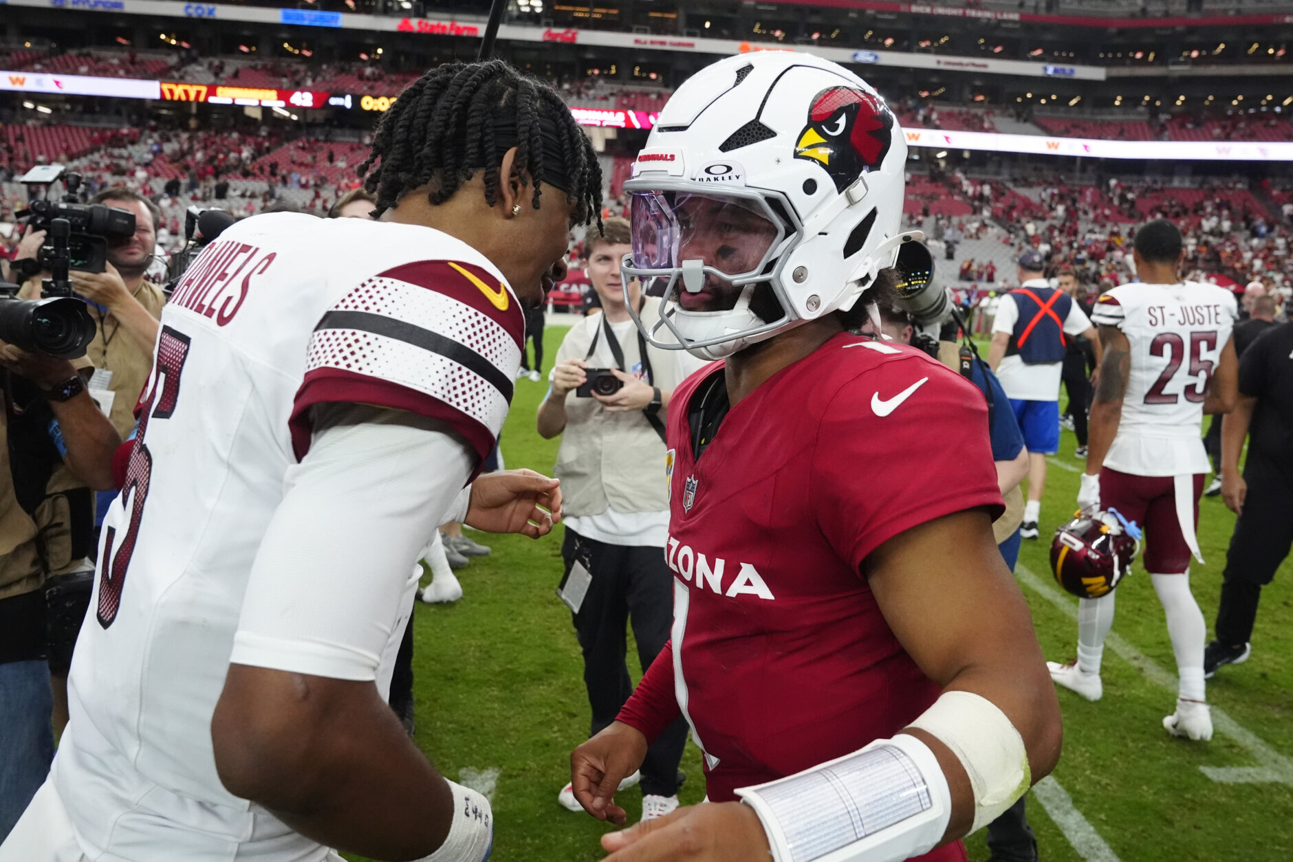 Washington Commanders quarterback Jayden Daniels, left, greets Arizona Cardinals quarterback Kyler Murray after an NFL football game, Sunday, Sept. 29, 2024, in Glendale, Ariz. (AP Photo/Ross D. Franklin)