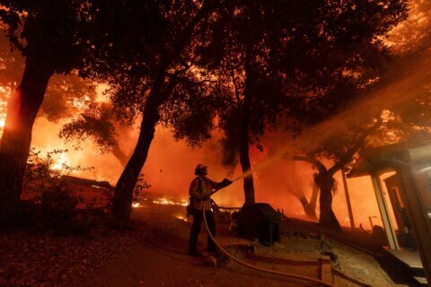 Wildfires scorch Southern California hillside homes. More are threatened