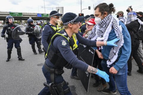 Anti-war protesters clash with police outside Australian weapons convention