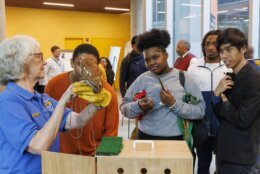 Students interact with Red, an 18-year-old screech owl, during an MOU signing with the U.S. Fish and Wildlife Service between Bowie State University, Alabama A&amp;M and Bethune-Cookman University, Friday, Sept. 27, 2024. (Courtesy Bowie State University)