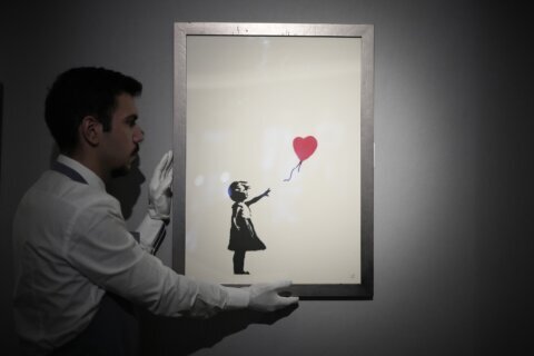 2 men charged with stealing a famous Banksy image from a London art gallery