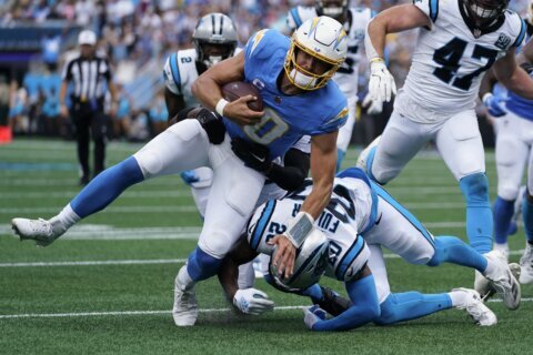 Chargers QB Justin Herbert's bid to play on a balky right ankle ends with an early exit