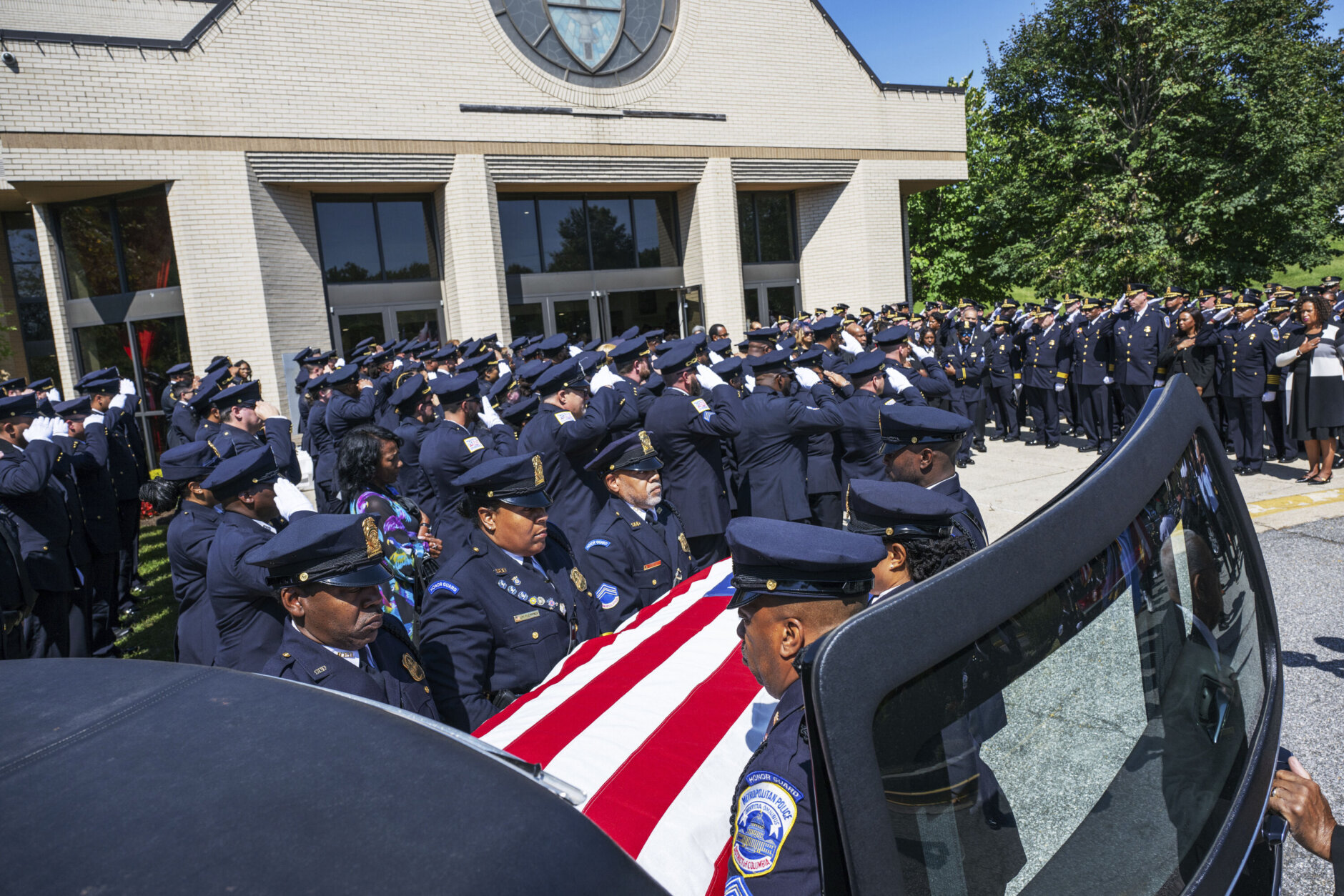 Pall bearers place the casket of D.C. police officer