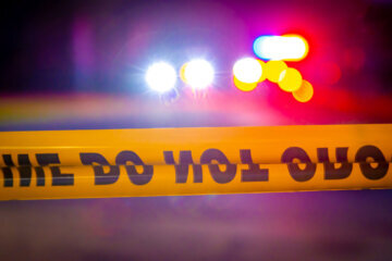 Police lights and yellow police tape at crime scene