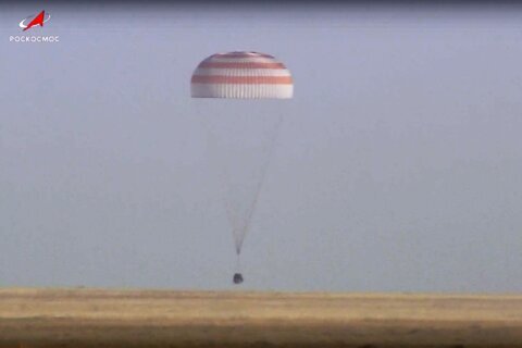 A Soyuz capsule with 2 Russians and 1 American from the International Space Station returns to Earth